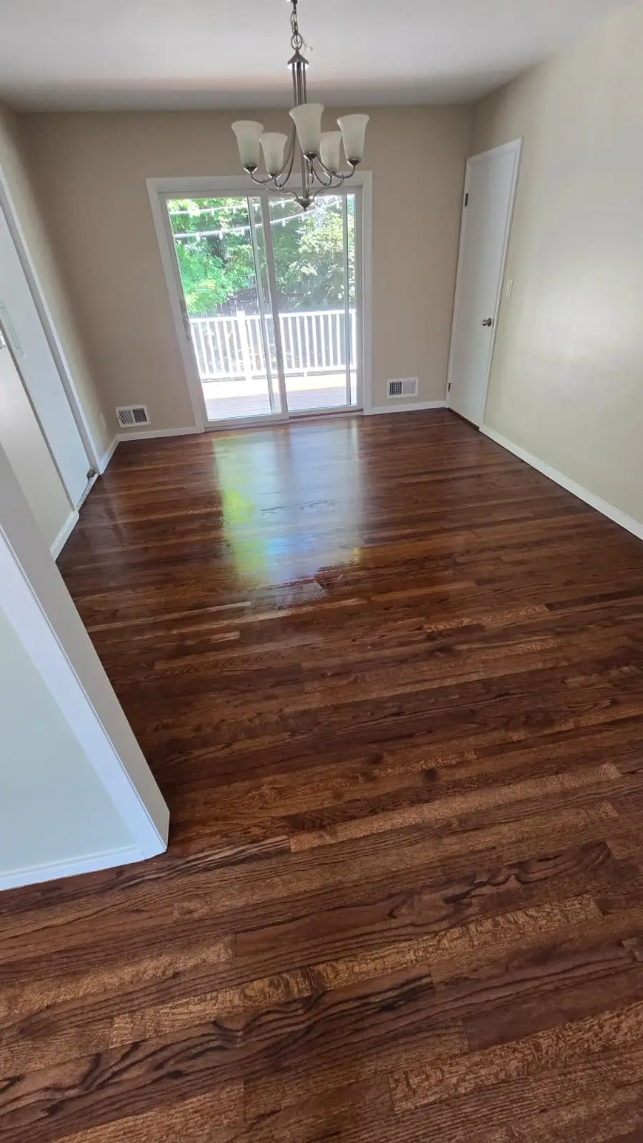 Room with new hardwood floor and sliding glass doors