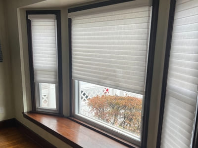 Bay window installation with custom blinds in a residential home, enhancing natural light and privacy.