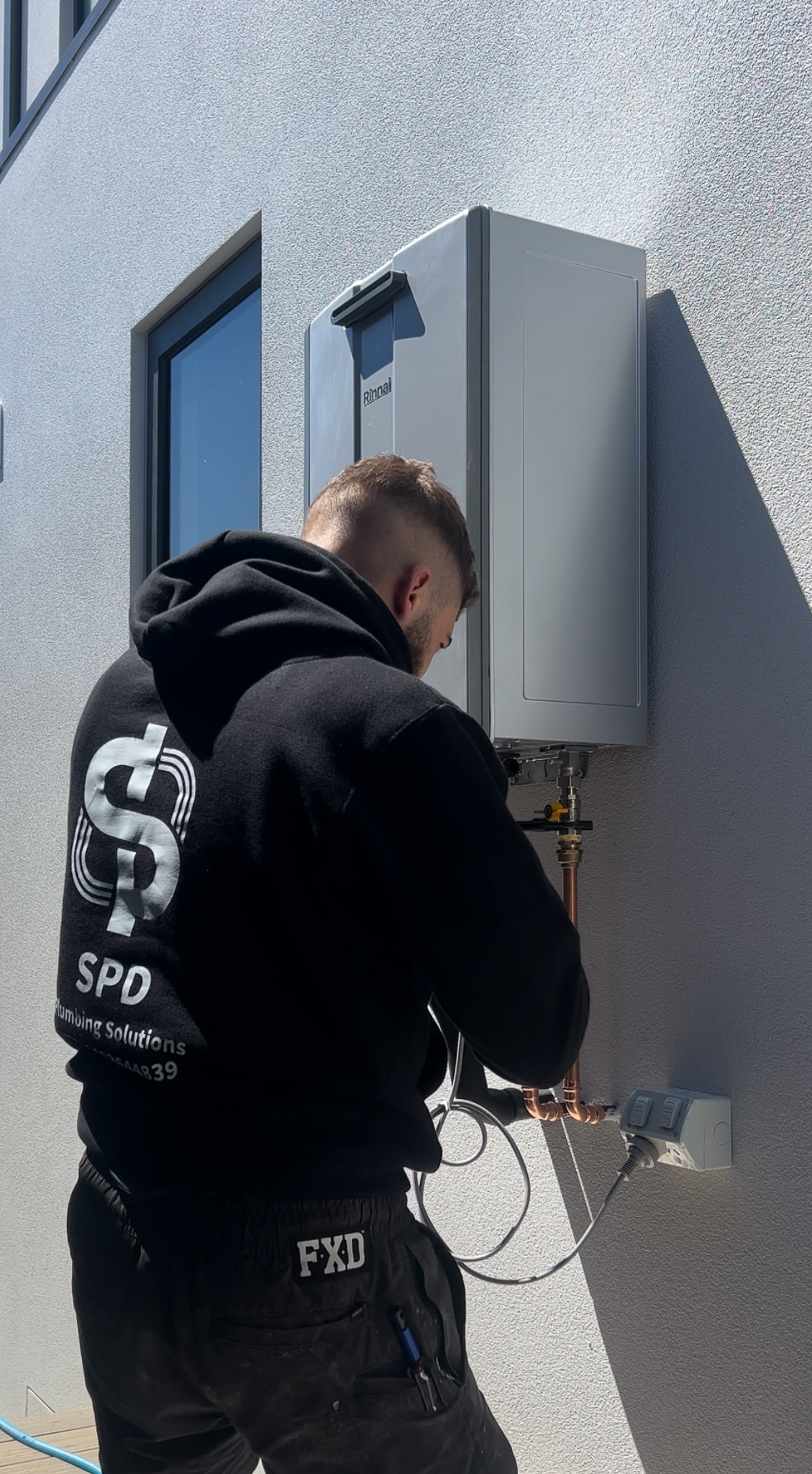 SPD Plumbing technician installing a hot water system