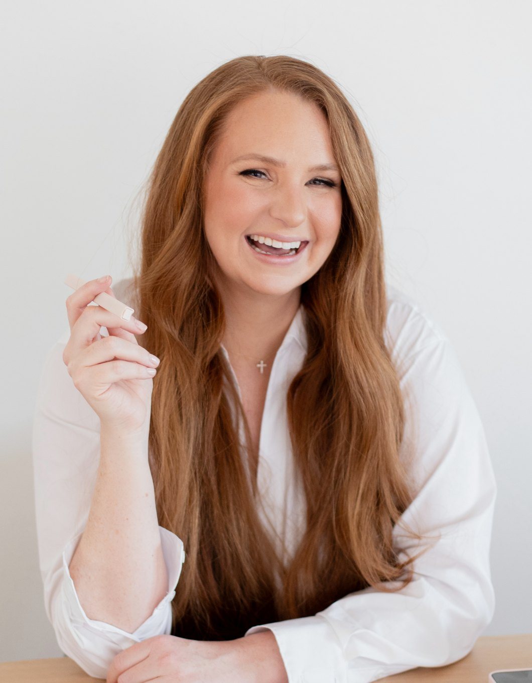 Kristina laughing at her desk