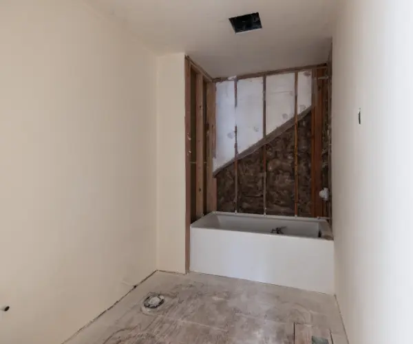 Custom front entry of a full home remodel in Tumalo, Oregon, featuring a custom wood door and natural stone accent wall. High-end residential entryway renovation in the Bend, OR area.