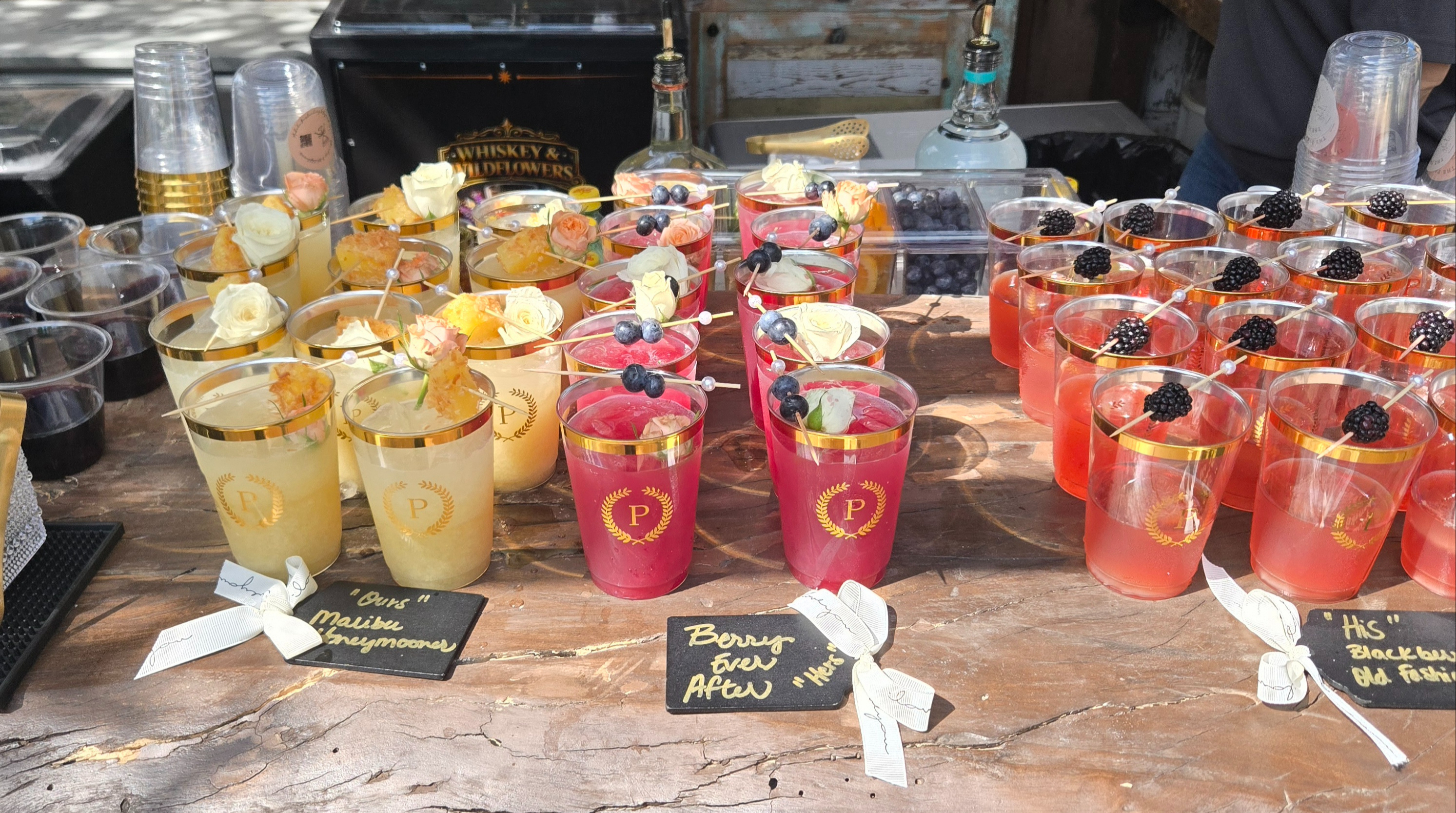 Rows of pre-batched his and hers signature cocktails staged for guest service