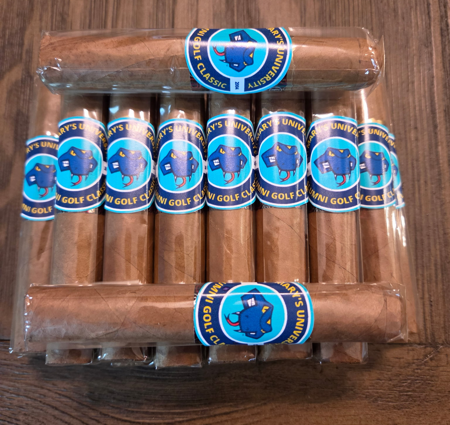 Bundle of premium cigars with custom Whiskey & Wildflowers golf bands