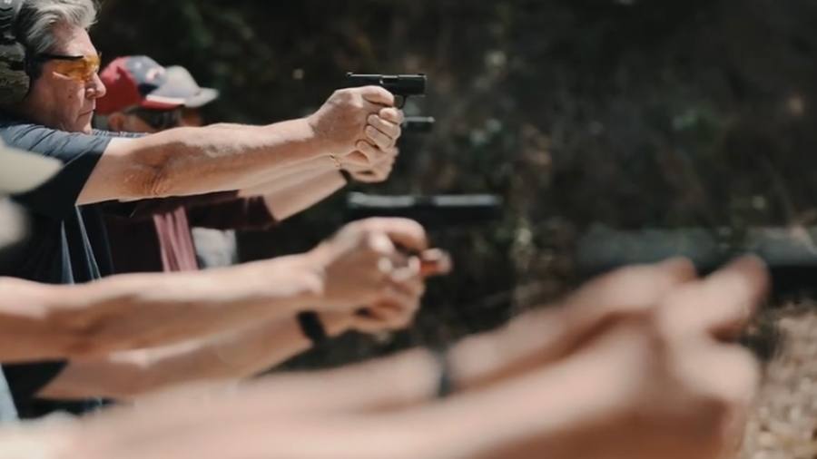 Students on the firing line, pistols up