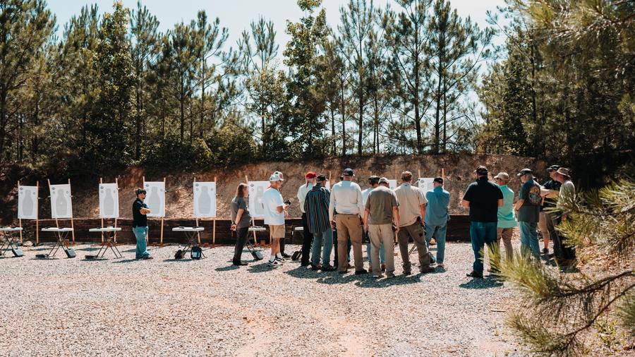 A PTC instructor coaching a class at the target line