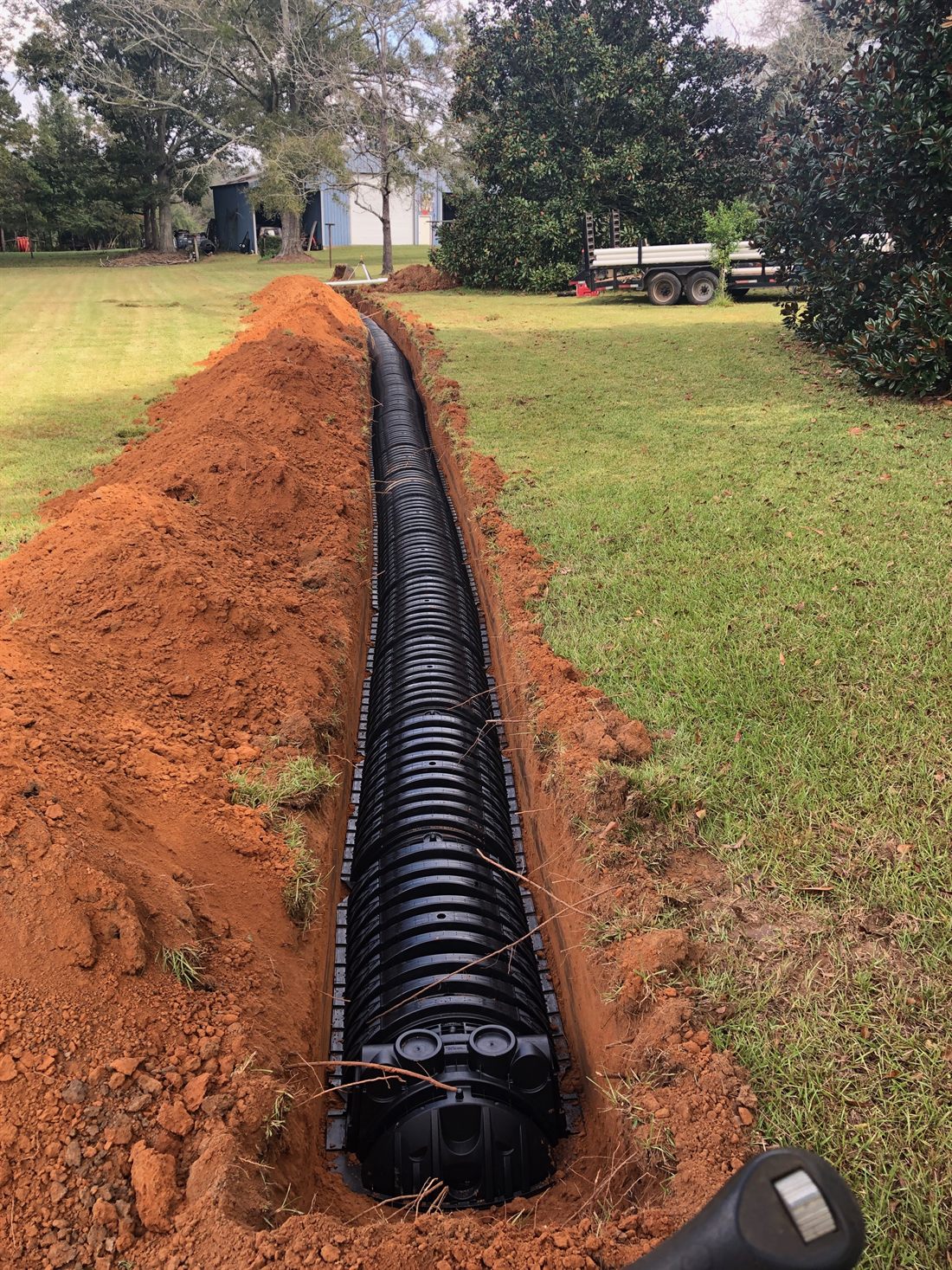 A gravelless EZflow drain-field line installed in red Mississippi clay by Holmes Septic