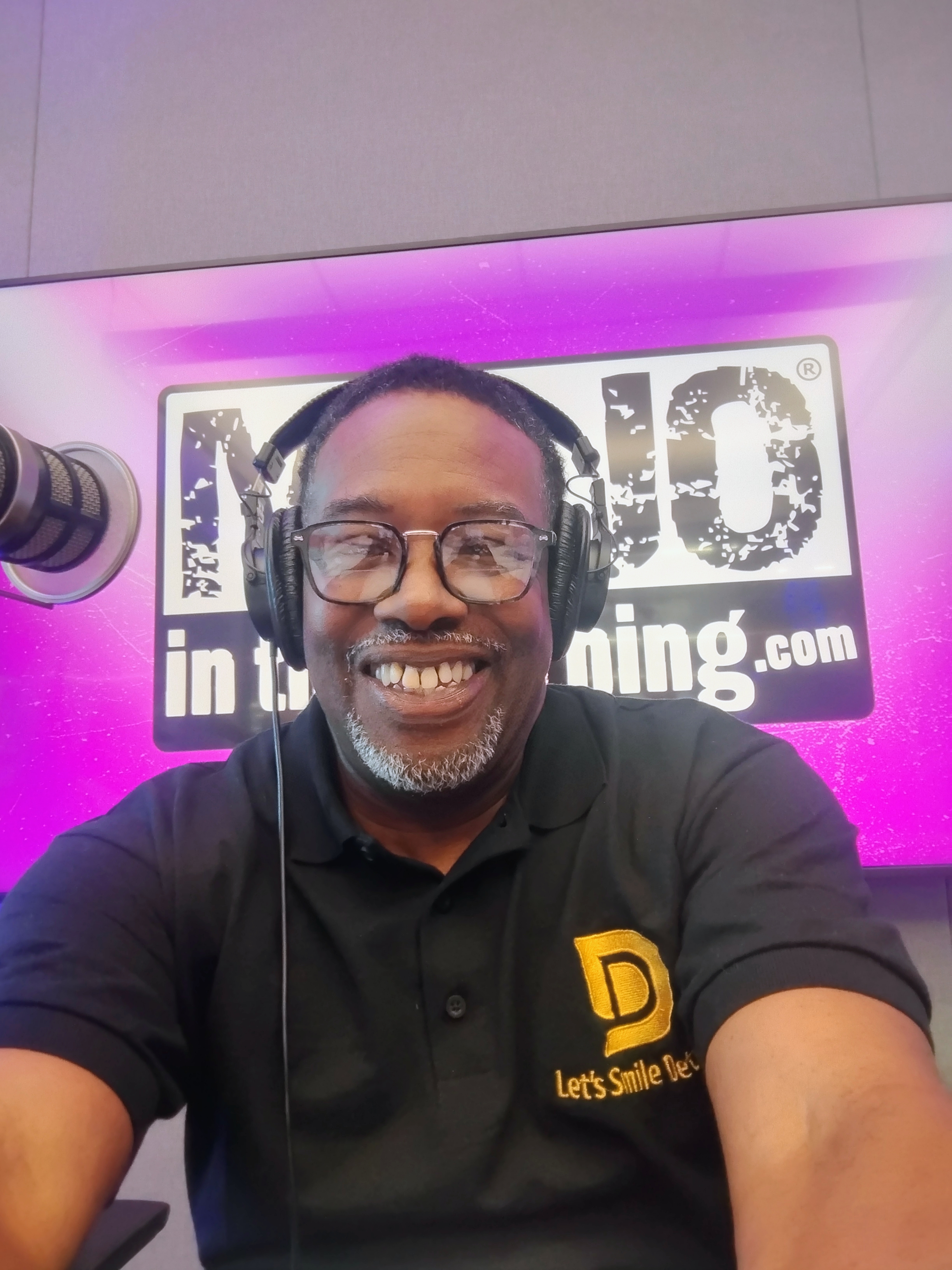 Dorian M. Graves wearing headphones beside a studio microphone