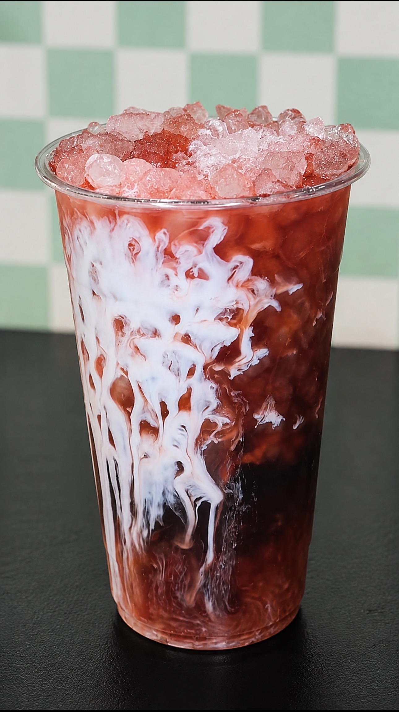 Red specialty drink with ice and cream