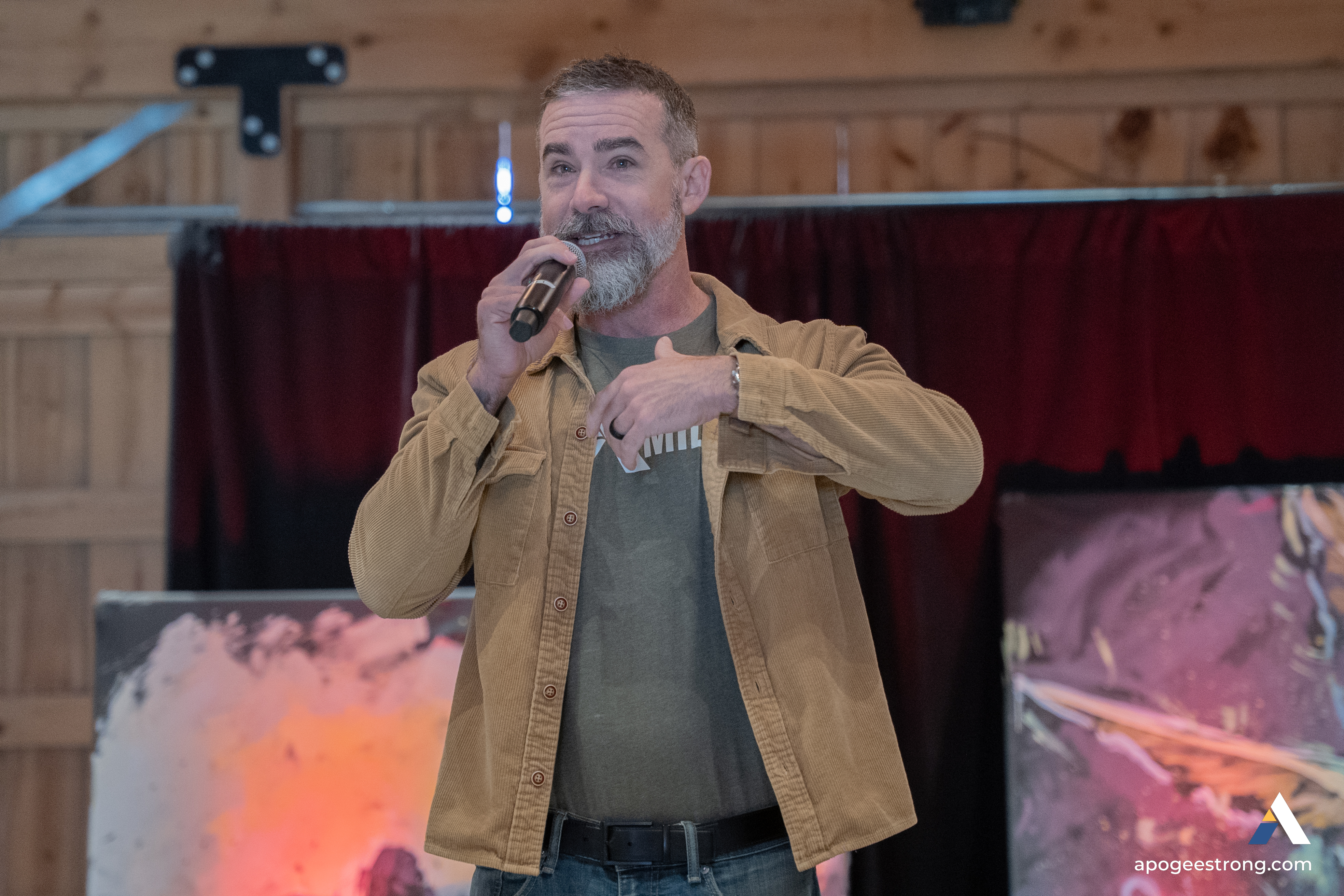 Matt Beaudreau on stage speaking to an audience