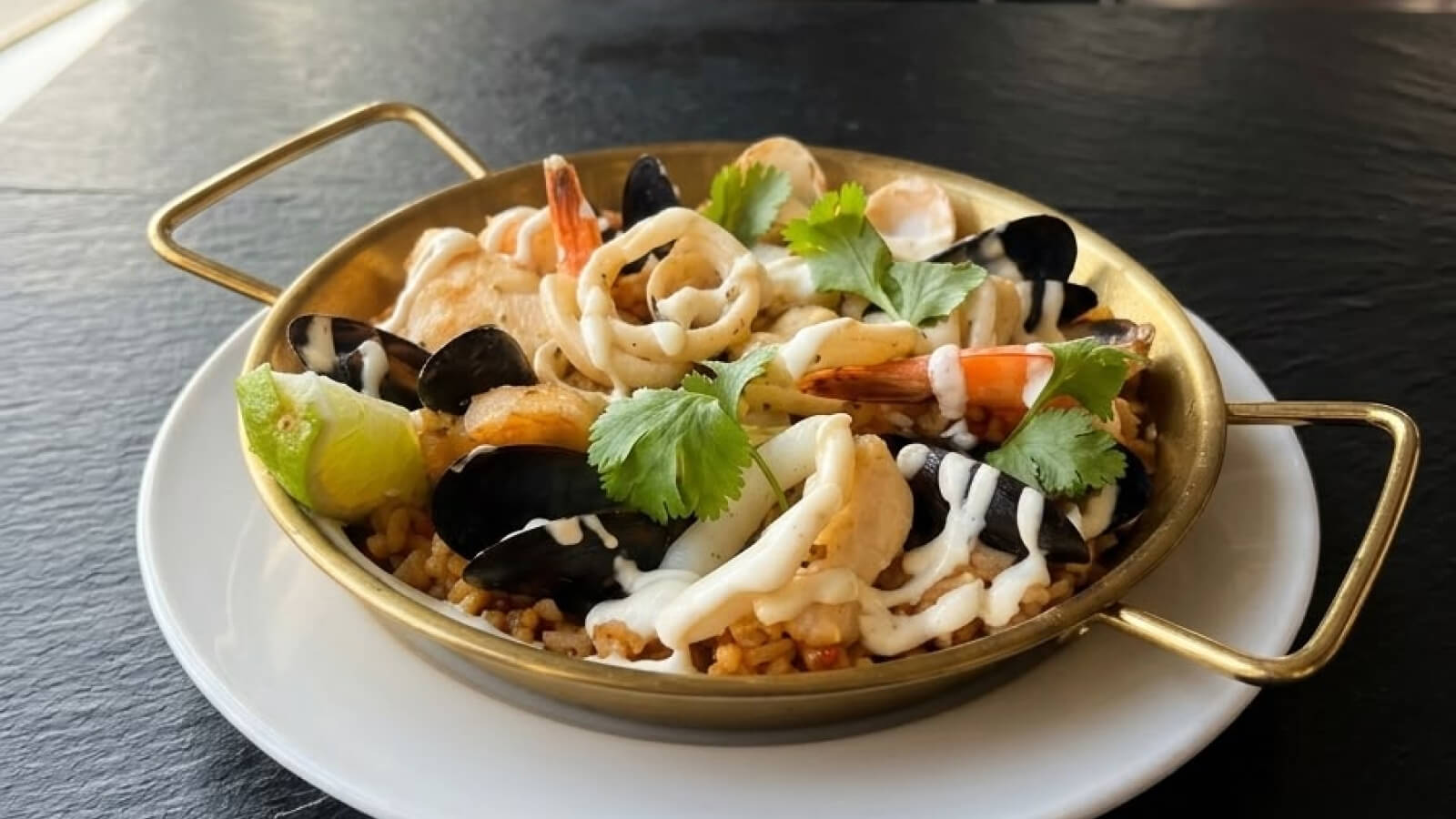 Delicious seafood paella incorporate lobster and other seasonal catches of the day