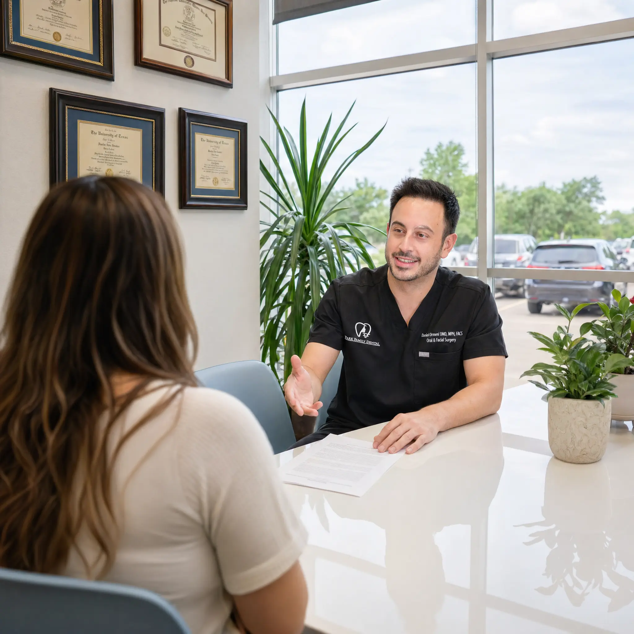 Dr. Daniel Ormeni reviewing a personalized wisdom tooth removal treatment plan with a patient in Cedar Park, TX