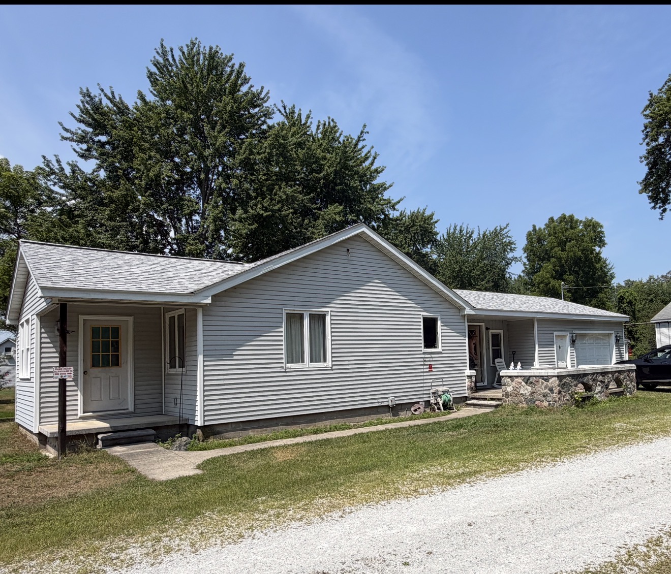 Single-story ranch home with attached garage and a new light-toned shingle roof.