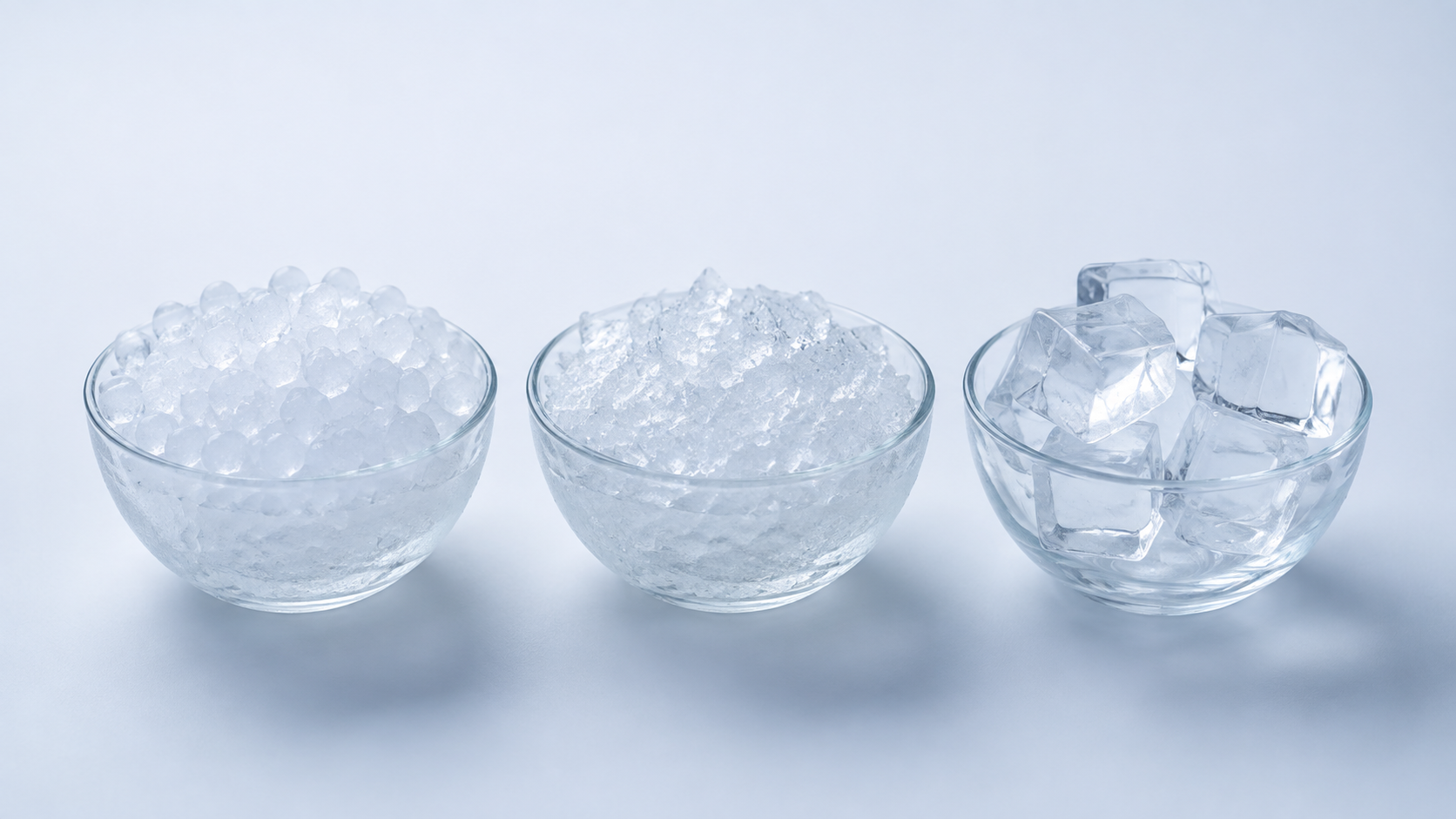 Nugget ice compared with crushed ice and regular ice cubes in three glass bowls