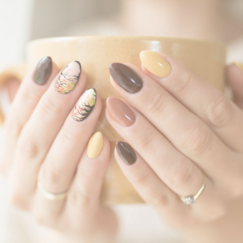 woman holding a cup of tea with nice nails 