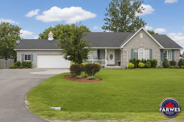 Grey brick Farwes bungalow with navy shutters, a cupola, and a covered porch