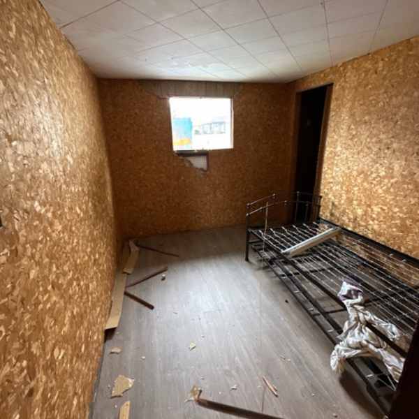 Room stripped to OSB walls before a Farwes renovation