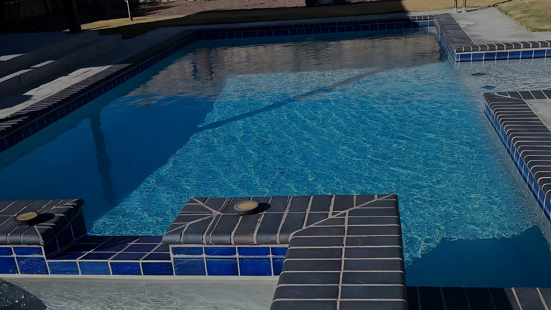 Custom pool with tiled raised spa built in El Paso