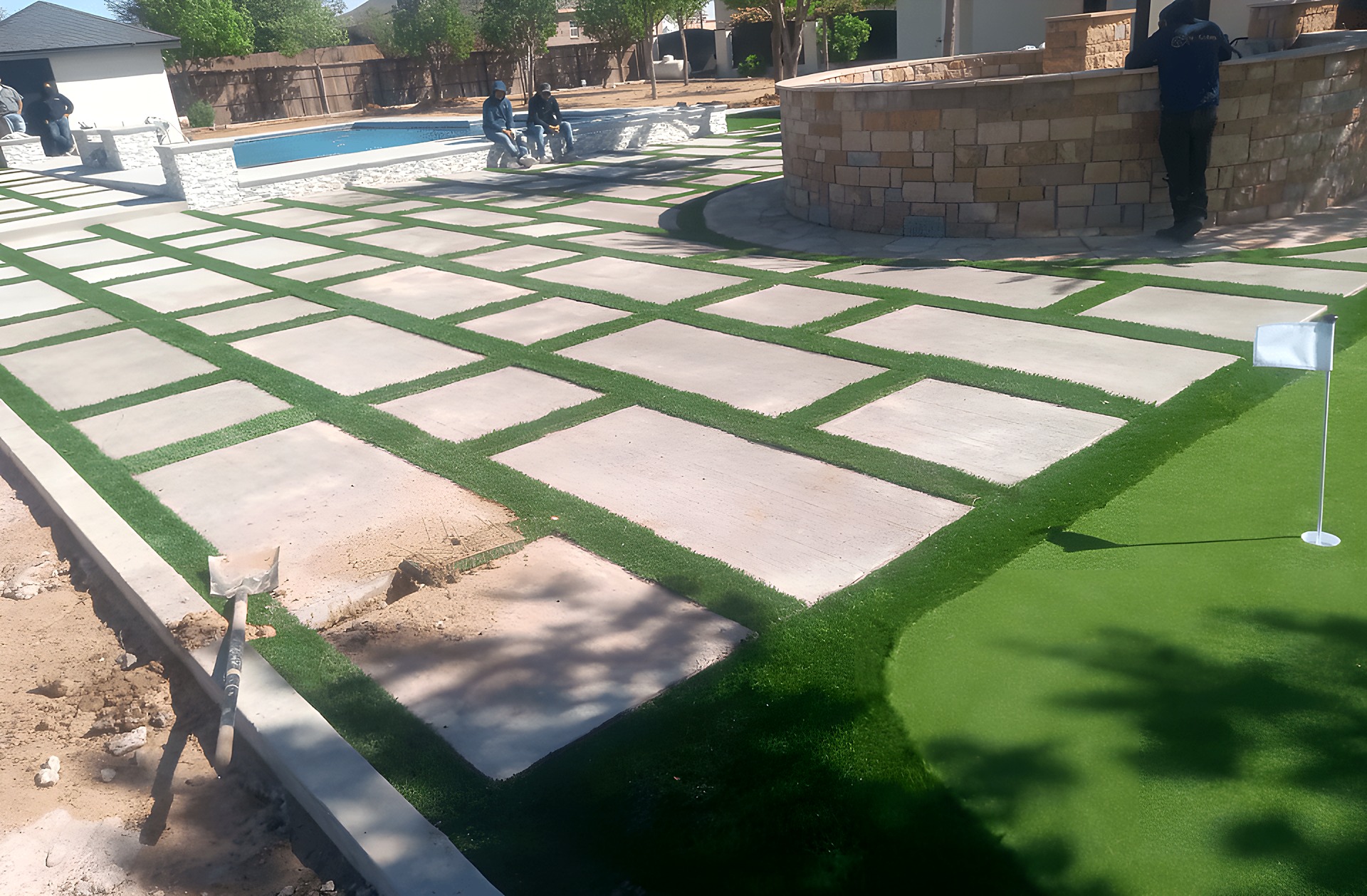 Pool landscaping with pavers and artificial turf in El Paso