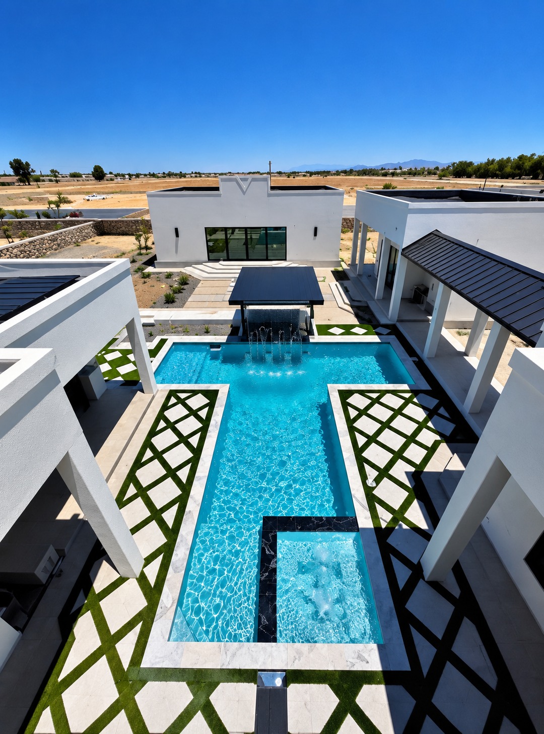 Luxury courtyard pool with sheer descent water feature, raised spa, marble coping and artificial turf diamond pavers built by Clearview Pools in El Paso, TX