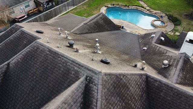 Aerial inspection. Those dark streaks are algae, so this house needs an algae-resistant shingle.