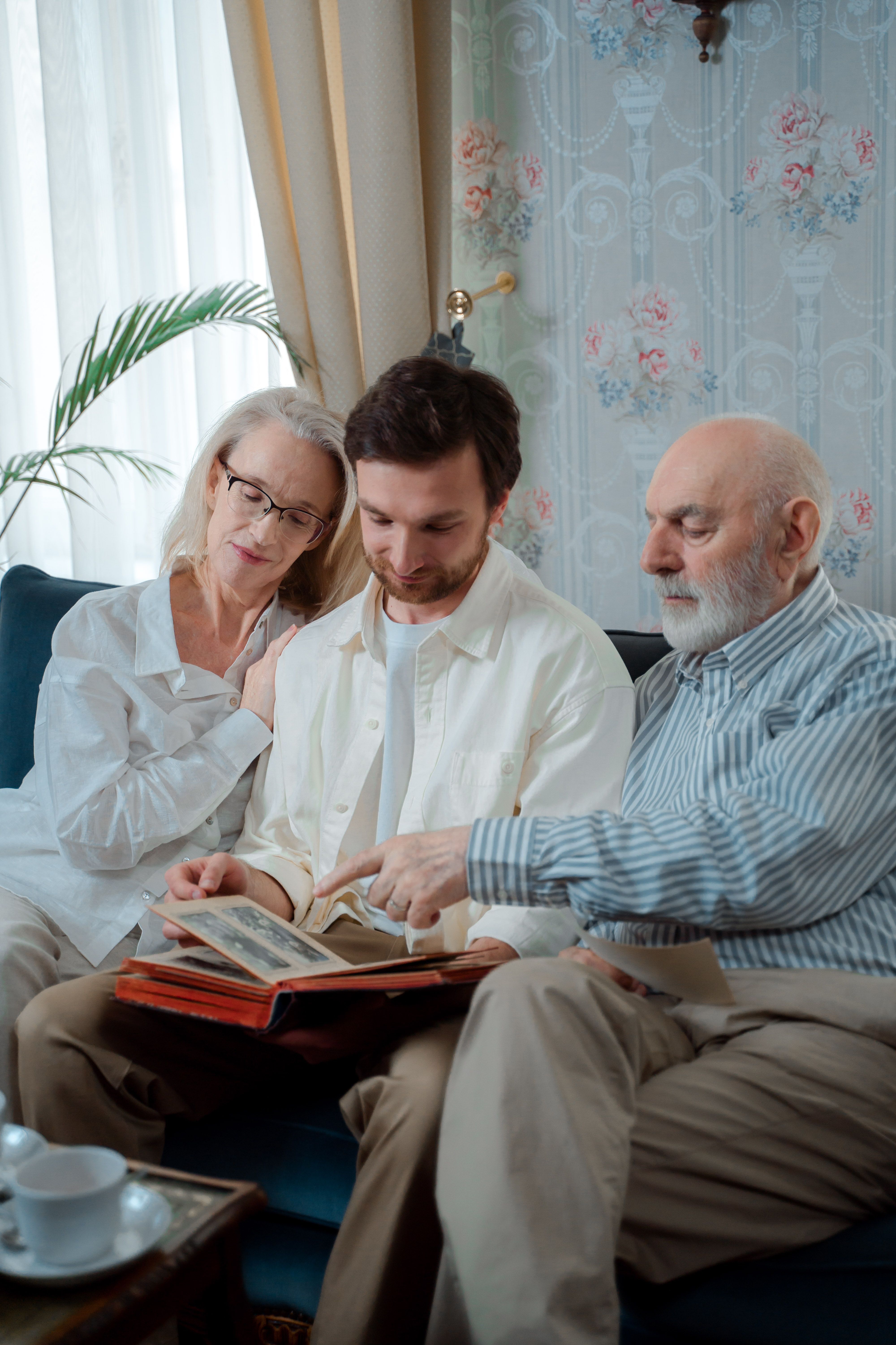 Family looking through a photo album together with their caregiver
