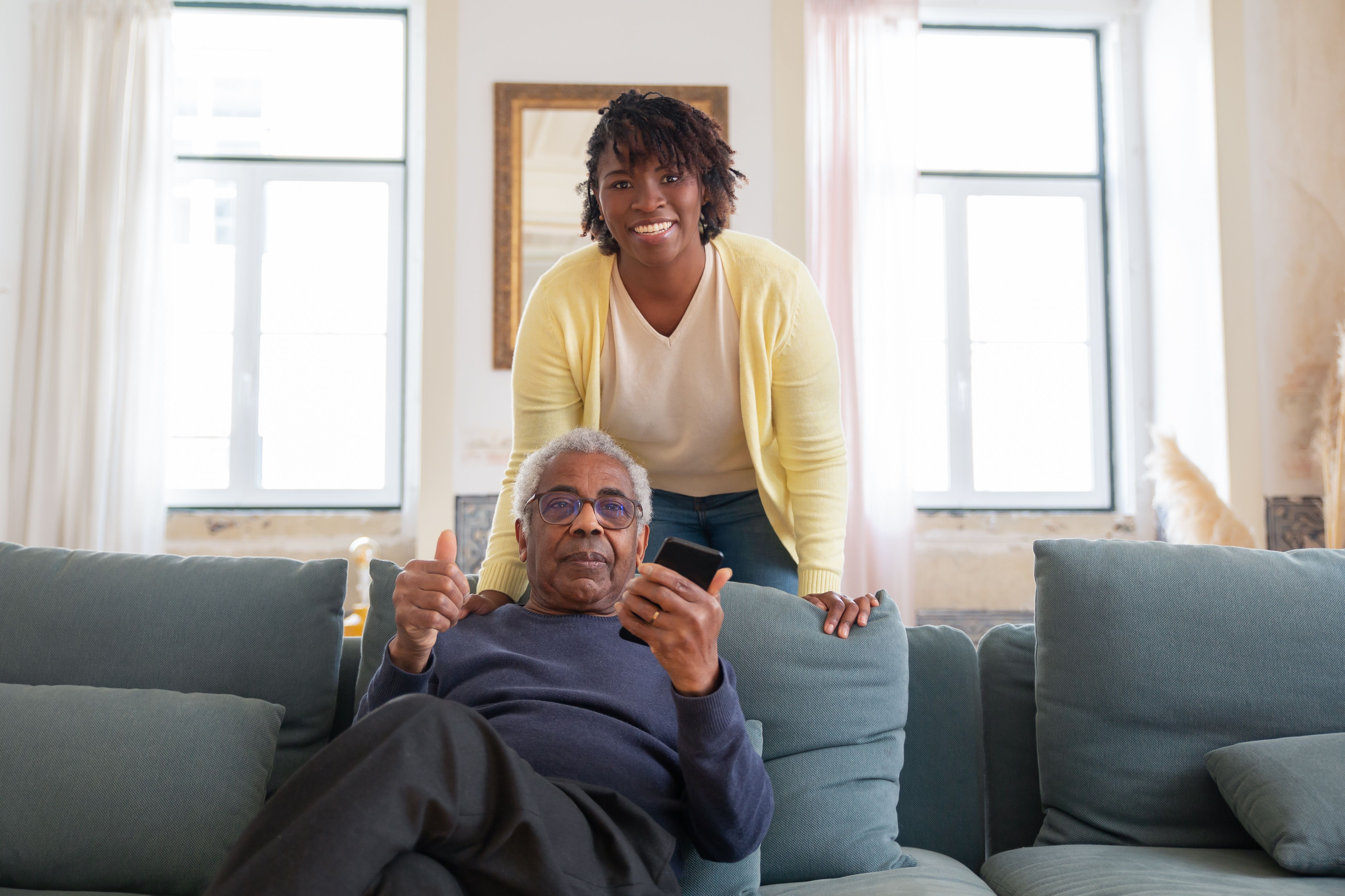 Caregiver and daughter with elderly mother at home