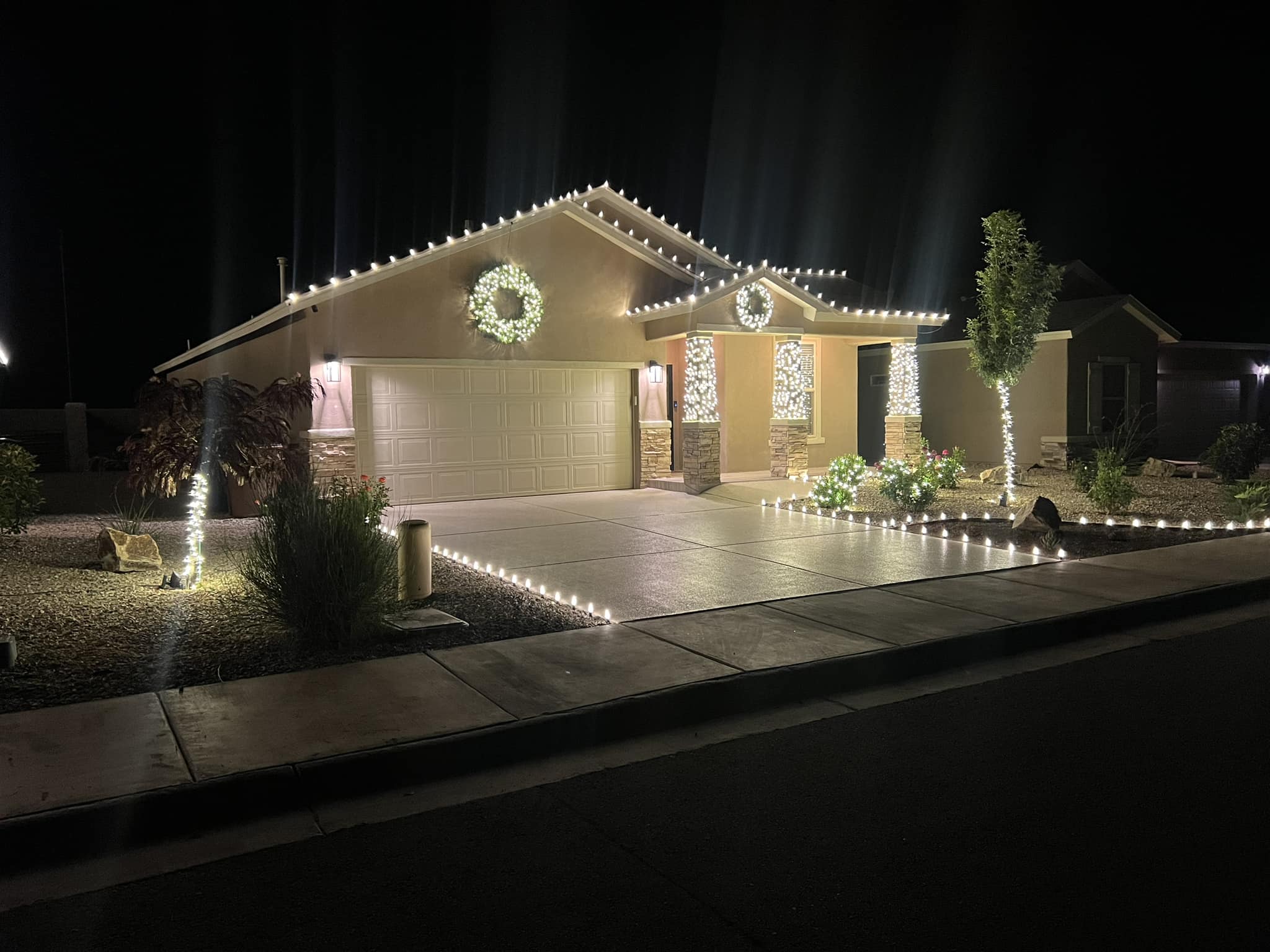 Professional Christmas light installation on a Clearwater FL home with roofline and columns illuminated