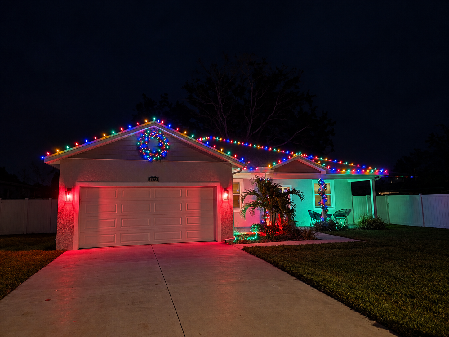 Residential holiday landscape lighting highlighting trees, shrubs, and outdoor features