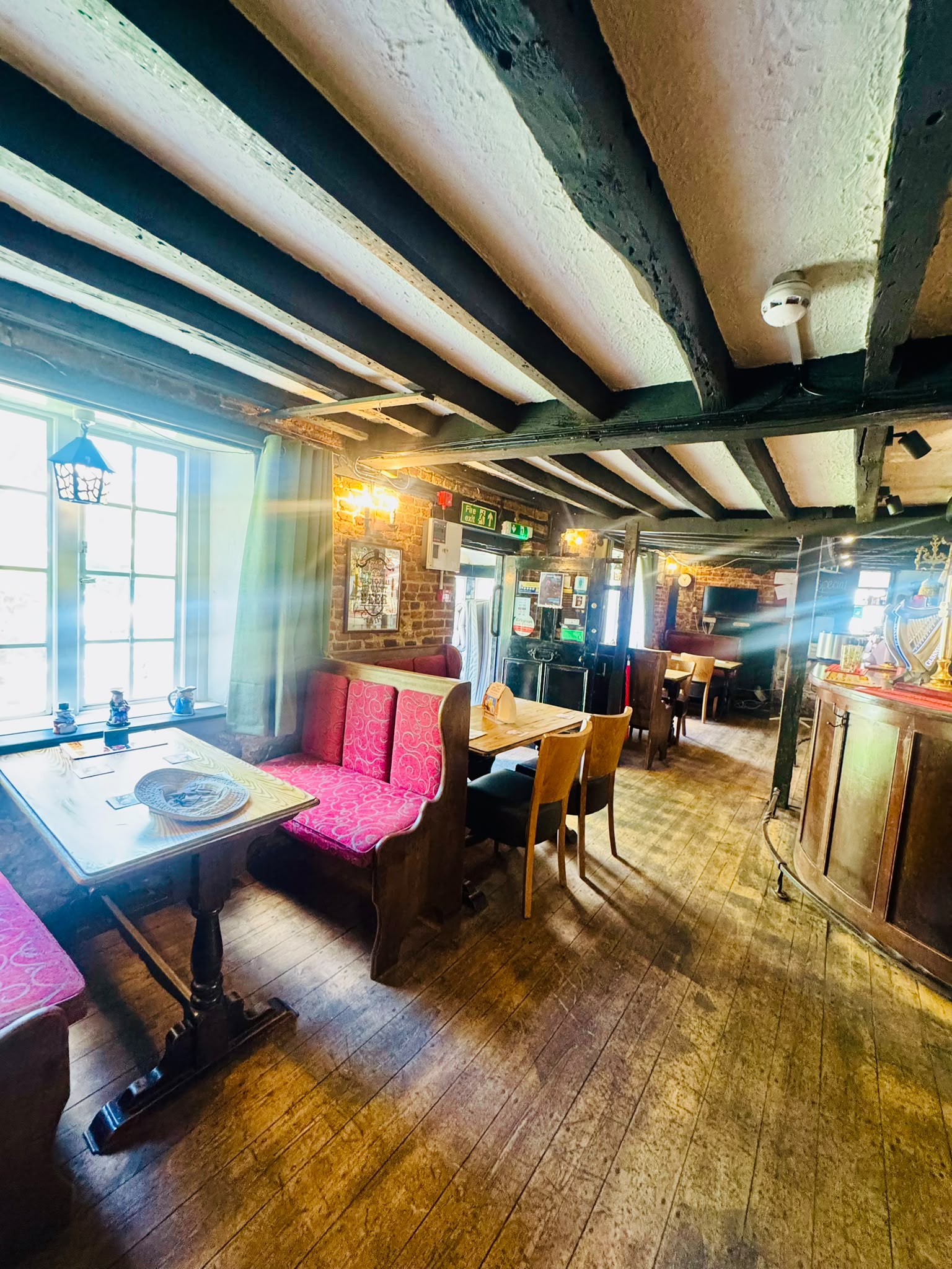 The cosy interior of The Anchor Bookham with beams and an open fire