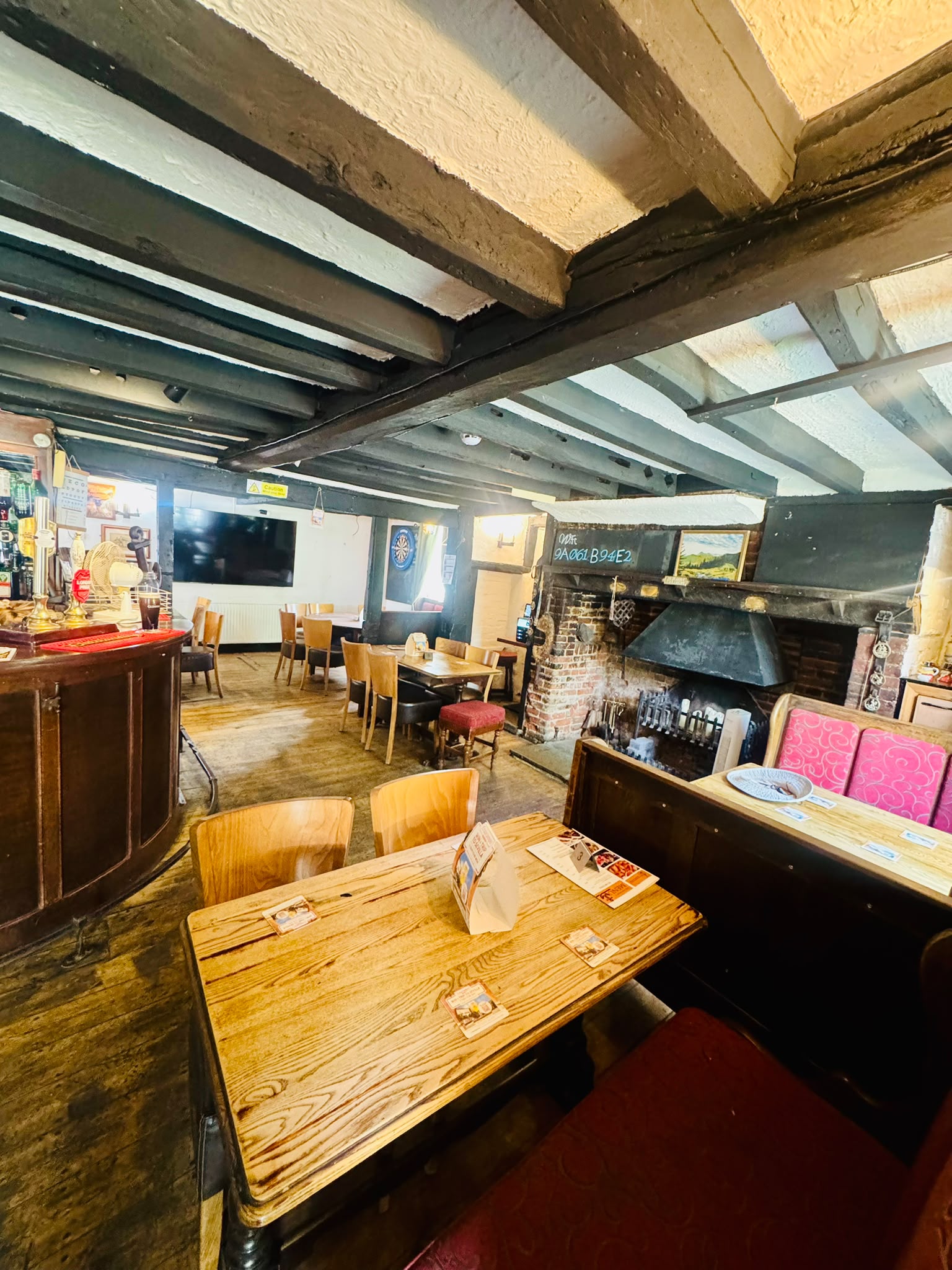 The warm interior of The Anchor Bookham, with exposed beams and an open fire, available for private functions
