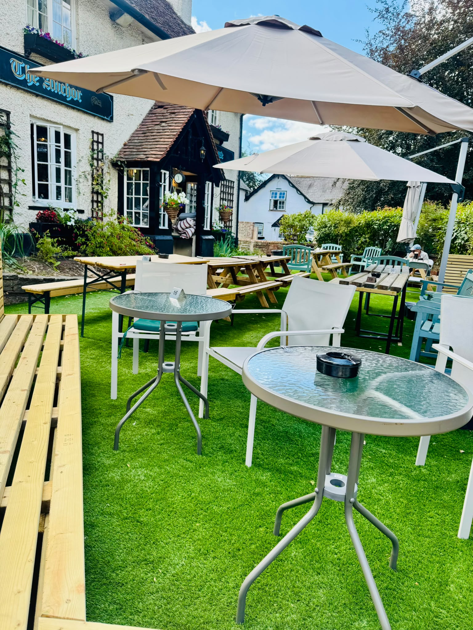 The Anchor Bookham beer garden with parasols and picnic benches, dog-friendly outdoor seating