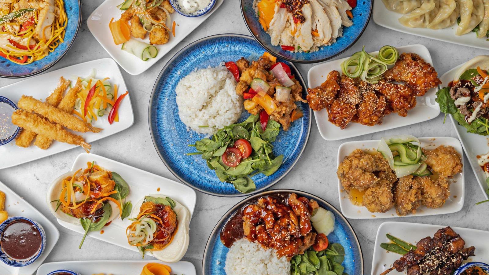A wide flat lay of Japanese and Korean dishes served at The Anchor Bookham