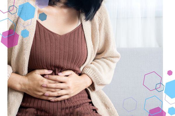 Person holding their abdomen, showing bloating and digestive discomfort that can be influenced by nervous system changes in early pregnancy. Person holding their abdomen, showing bloating and digestive discomfort that can be influenced by nervous system changes in early pregnancy.