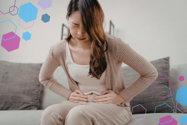 Person resting with a hand on their lower abdomen, illustrating abdominal sensations or one-sided pain sometimes experienced in early pregnancy.