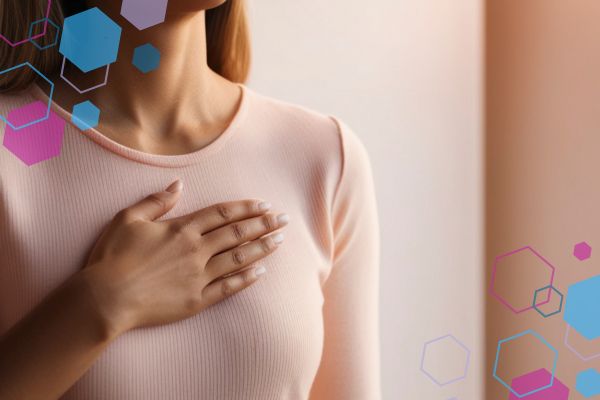 Person touching their chest, representing breast tenderness and sensitivity that can occur in early pregnancy.