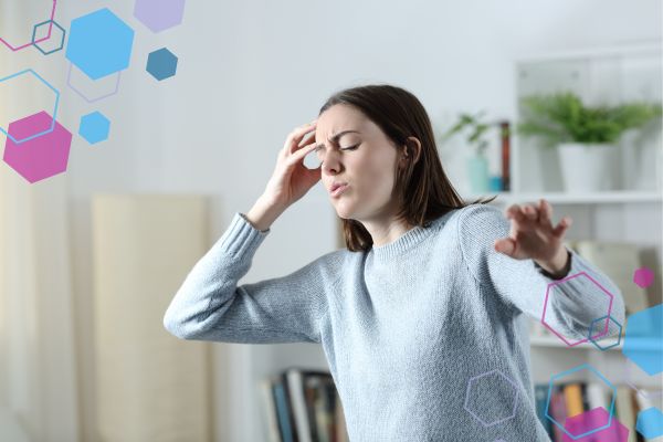 Person feeling unsteady and holding their forehead, representing light headedness that can occur in early pregnancy.