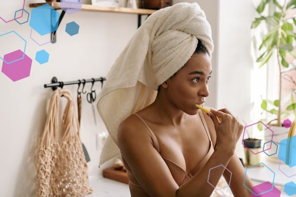Person brushing their teeth while looking to the side, illustrating gag reflex sensitivity during tooth brushing in early pregnancy. Person brushing their teeth while looking to the side, illustrating gag reflex sensitivity during tooth brushing in early pregnancy.