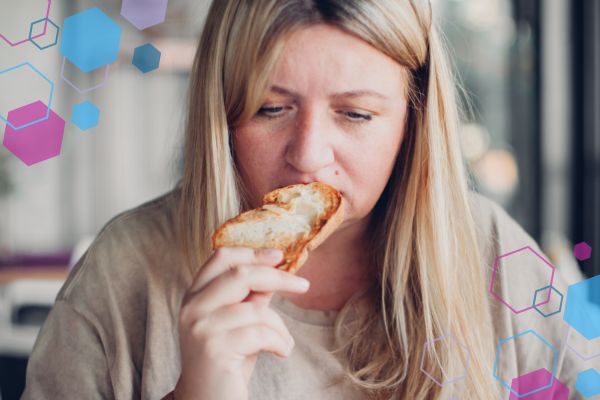 Person eating bread with a concerned expression, illustrating a strange or metallic taste in early pregnancy. Person eating bread with a concerned expression, illustrating a strange or metallic taste in early pregnancy.