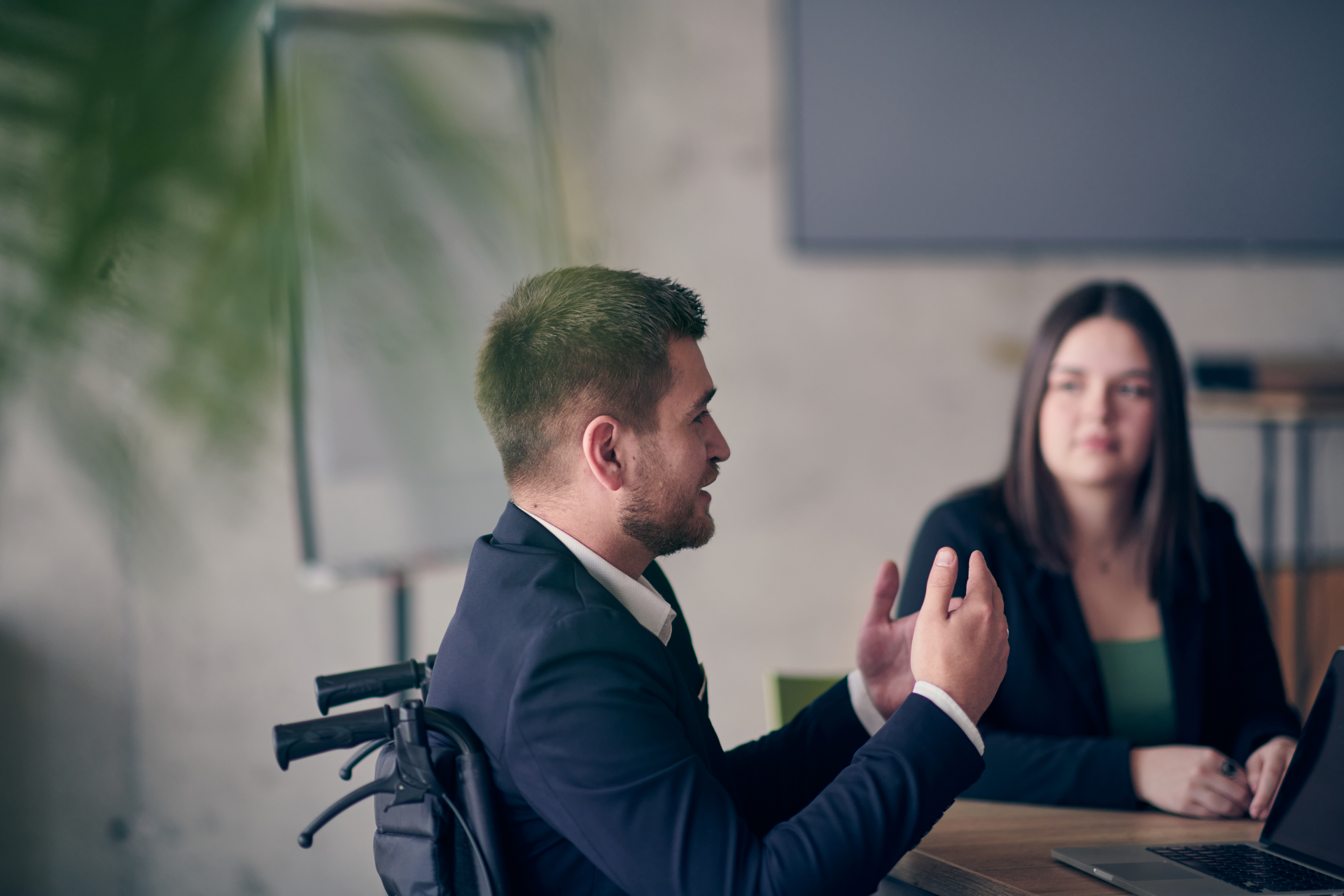 A wheelchair user leading a conversation in the workplace