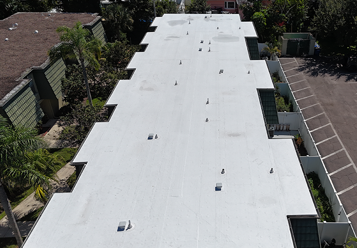 Aerial view of flat white roof replacement on commercial building in Florida