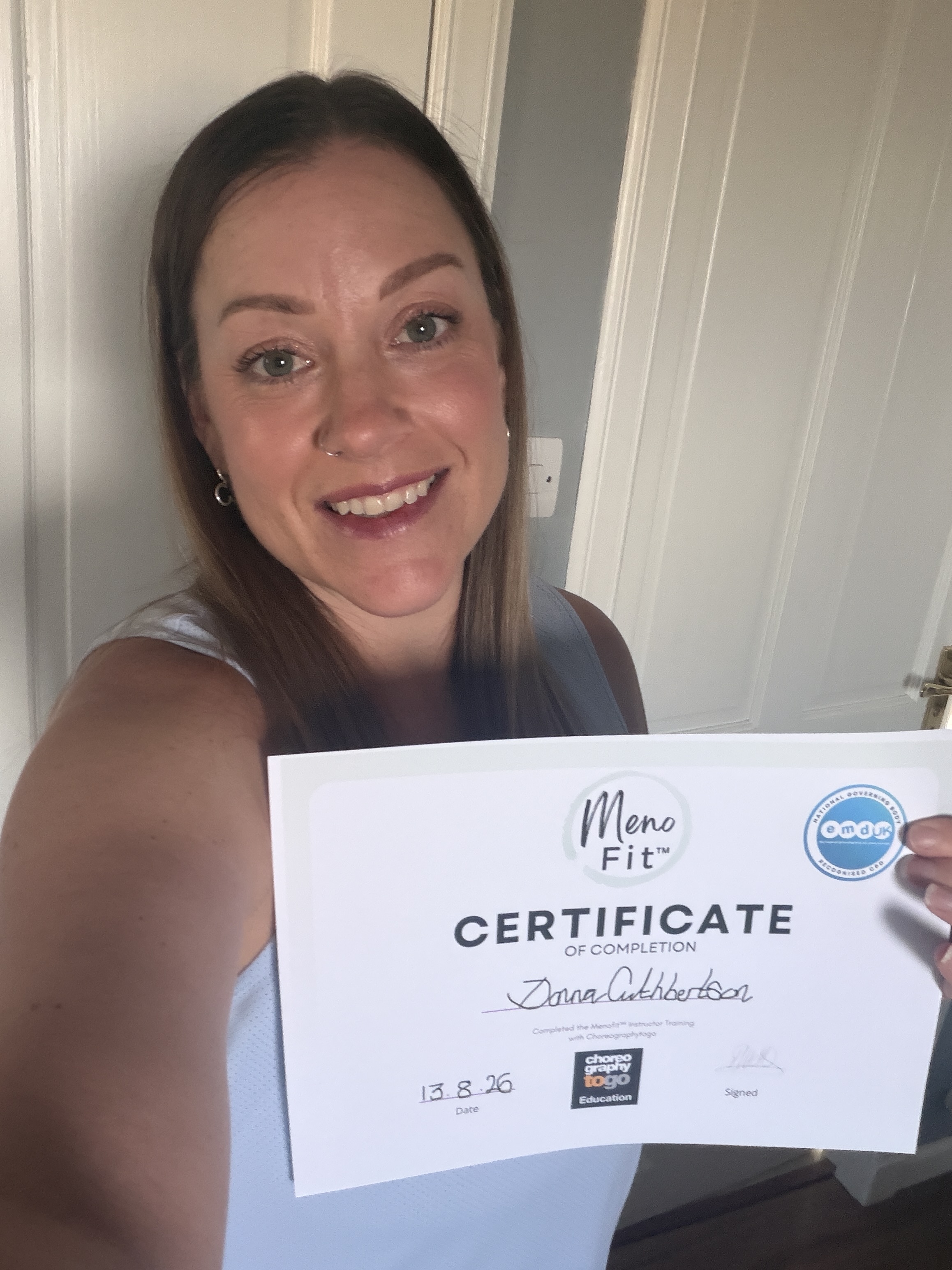 - Donna Cuthbertson holding her MenoFit menopause fitness qualification certificate - Donna Cuthbertson holding her MenoFit menopause fitness qualification certificate