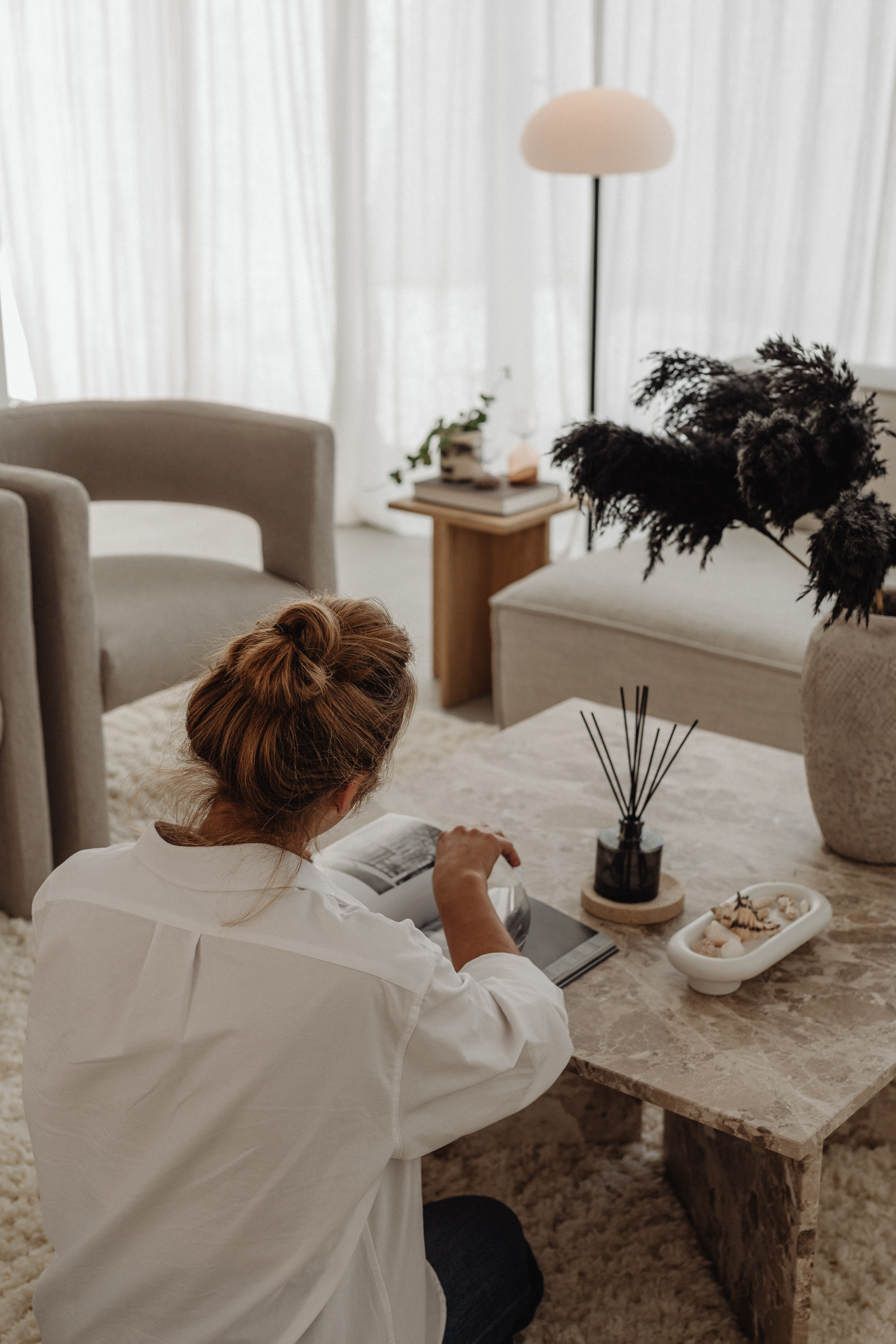 Woman sitting at table reading a book