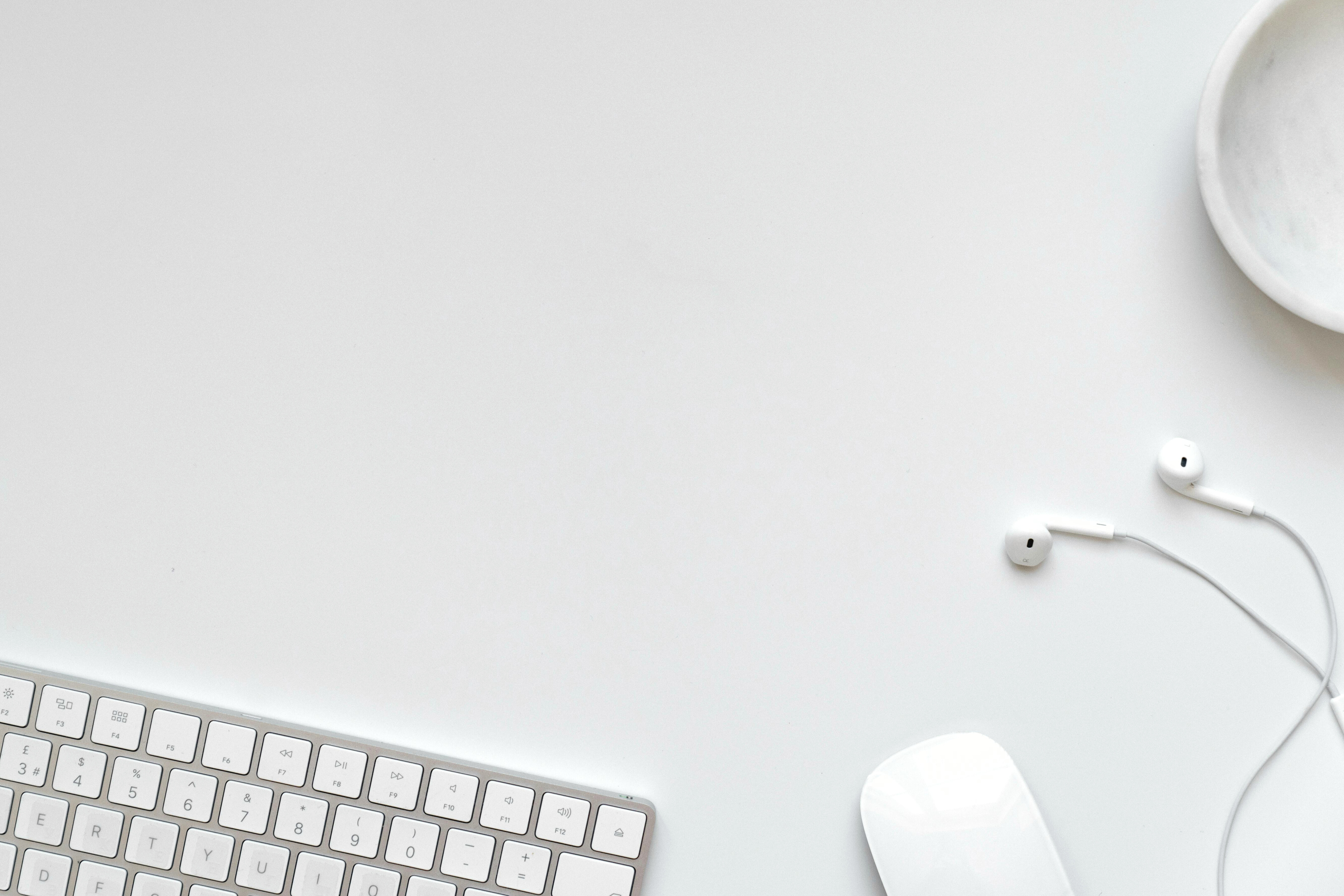 Earphones on a desk with keyboard