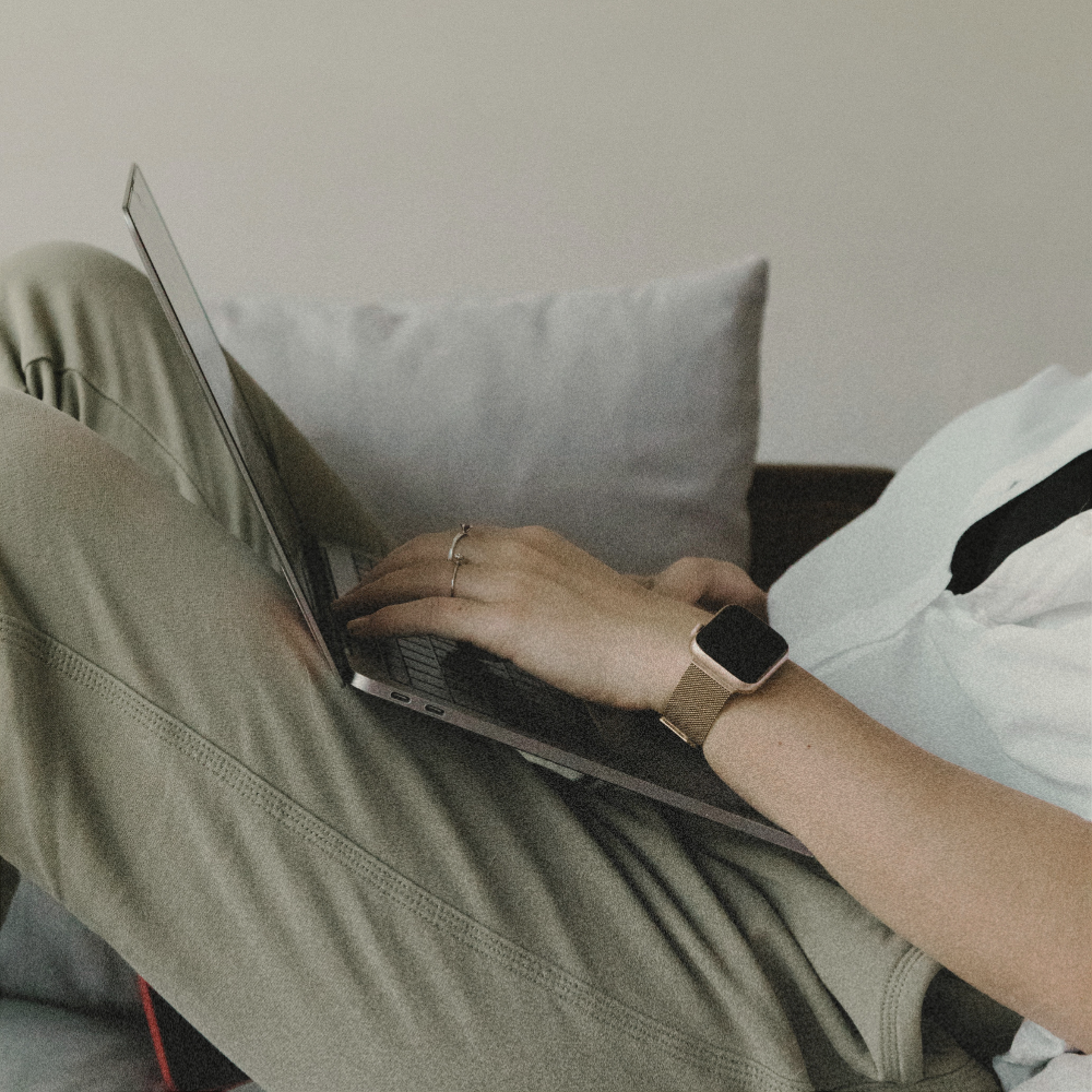 Computer desk against a white painted brick wall