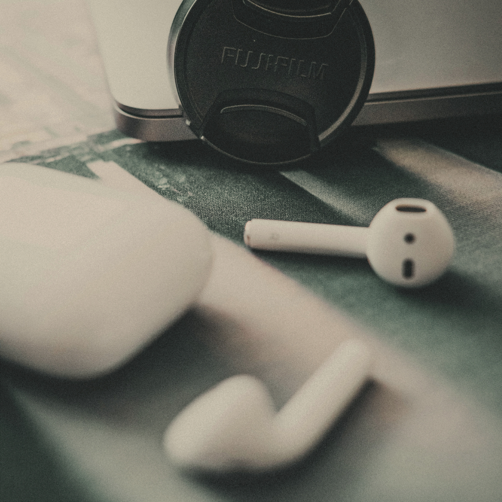 Earphones on a desk with keyboard
