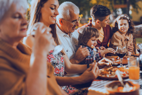 Family enjoying dinner in a luxury outdoor kitchen.