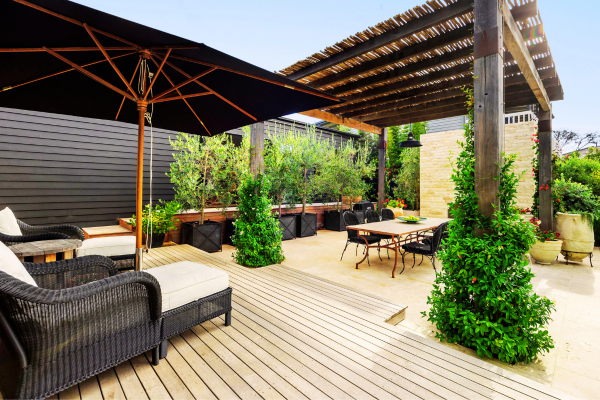 Luxury composite backyard deck with outdoor furniture.