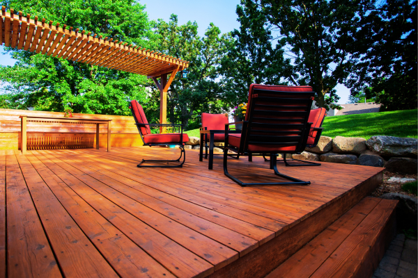 Luxury deck with pergola and outdoor kitchen.