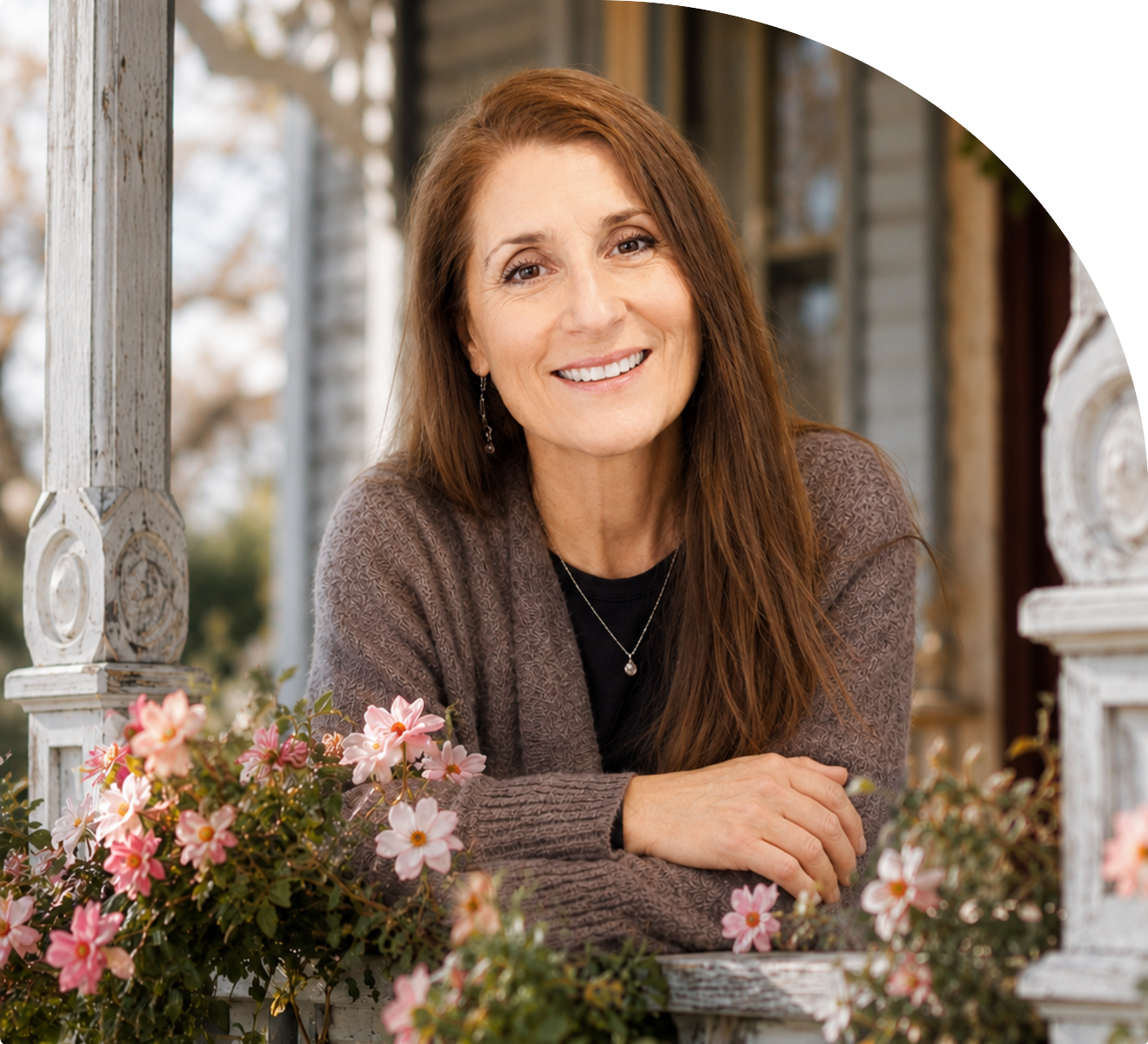 Dr. Irene Blinston smiling on a flower-filled porch