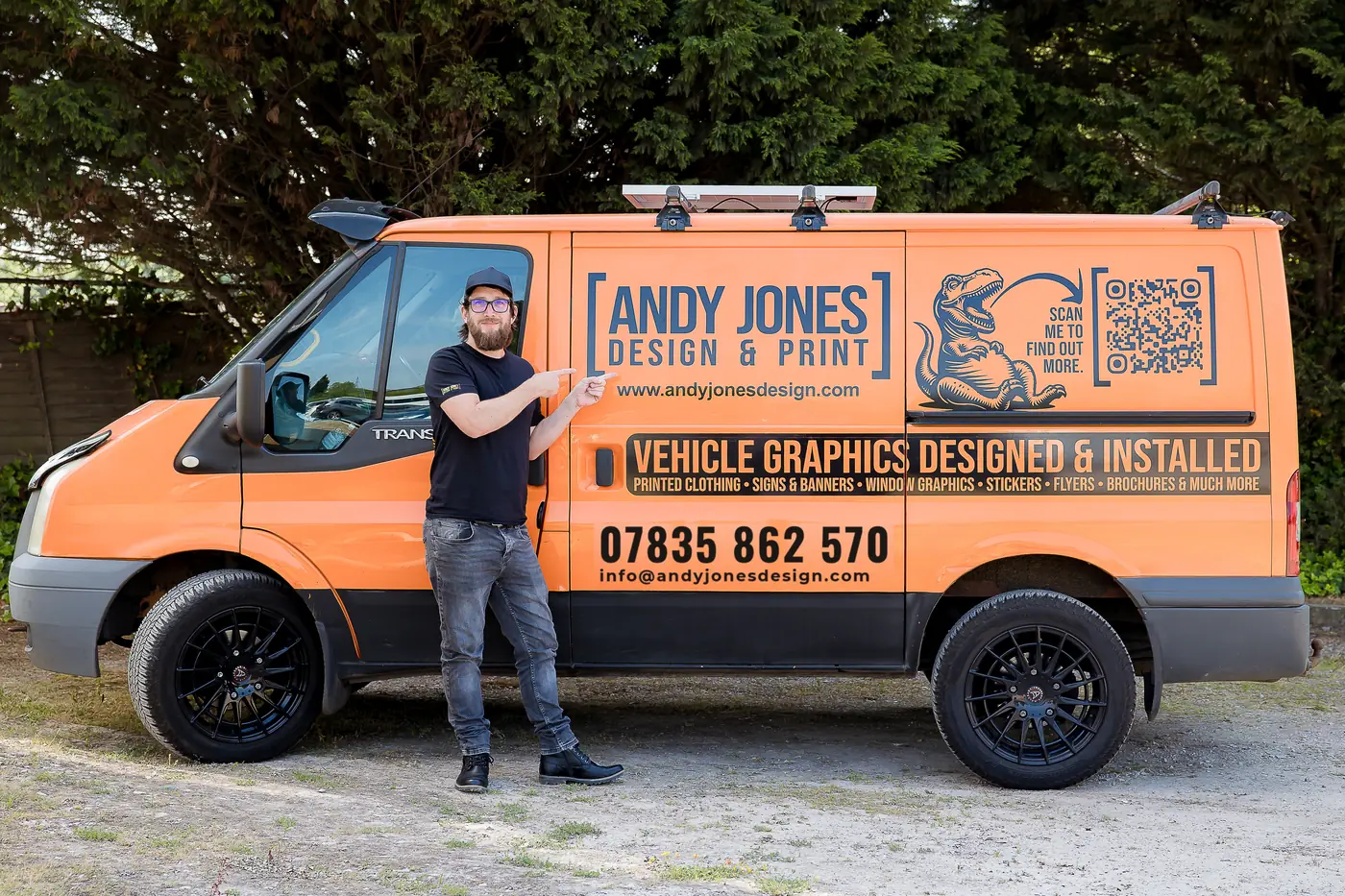 Andy Jones with his orange branded van, which he designed and fitted